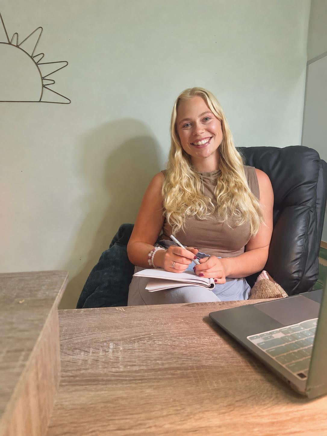 Emerald Weninger at her desk preparing for an online counselling session